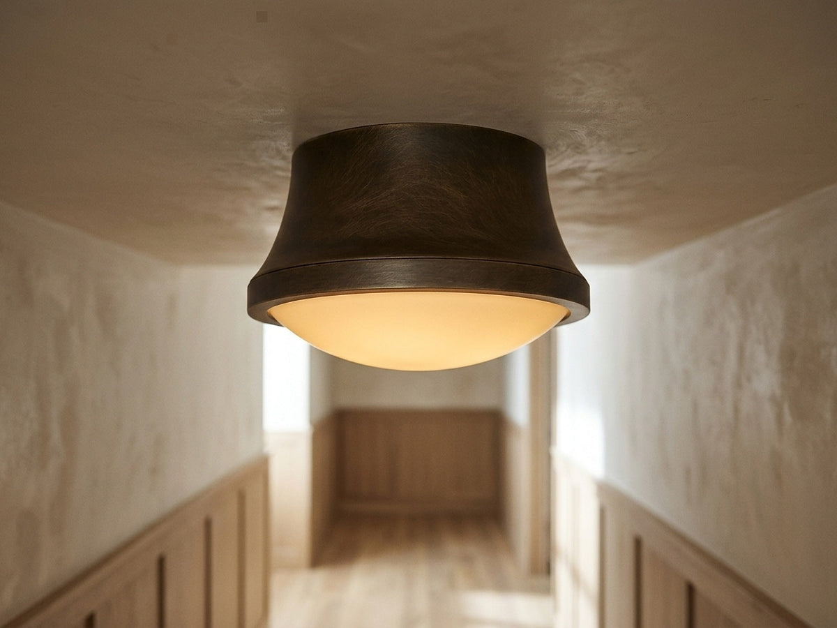 Enclosed opal flush mount glowing on a hallway ceiling