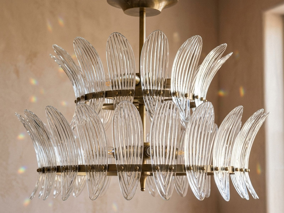 Spotless crystal chandelier catching daylight and throwing prisms