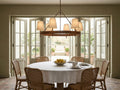 Hastings 6 Light Round Chandelier above a round table in a garden room