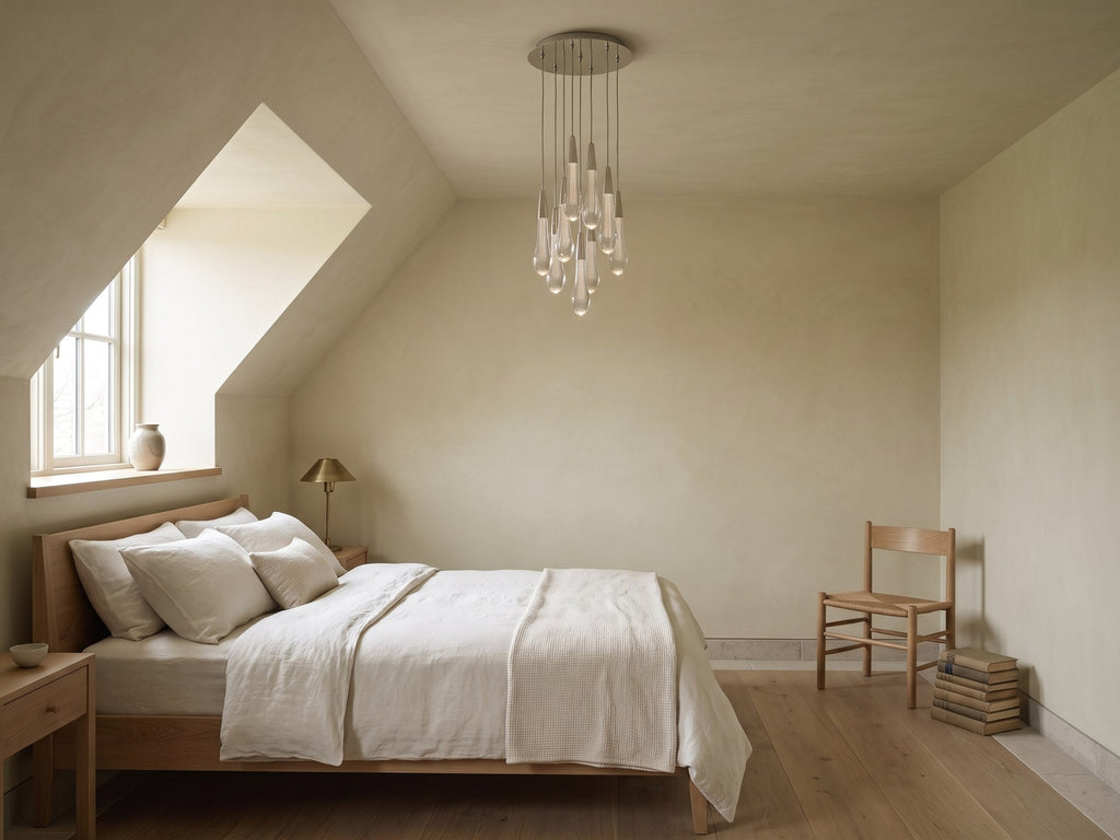 Soltaire Round Chandelier in Nickel in a guest bedroom with a sloped ceiling