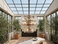 Blaire Round Chandelier in Clear in a glass-roofed sunroom