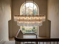 Delsie Oval Tiered Chandelier in a two-storey stair hall